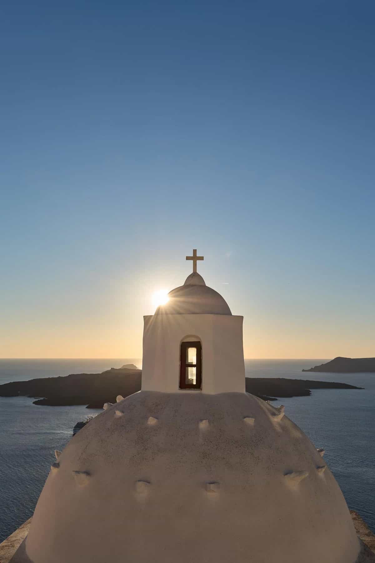 Golden hour caldera view with whitewashed buildings in Fira