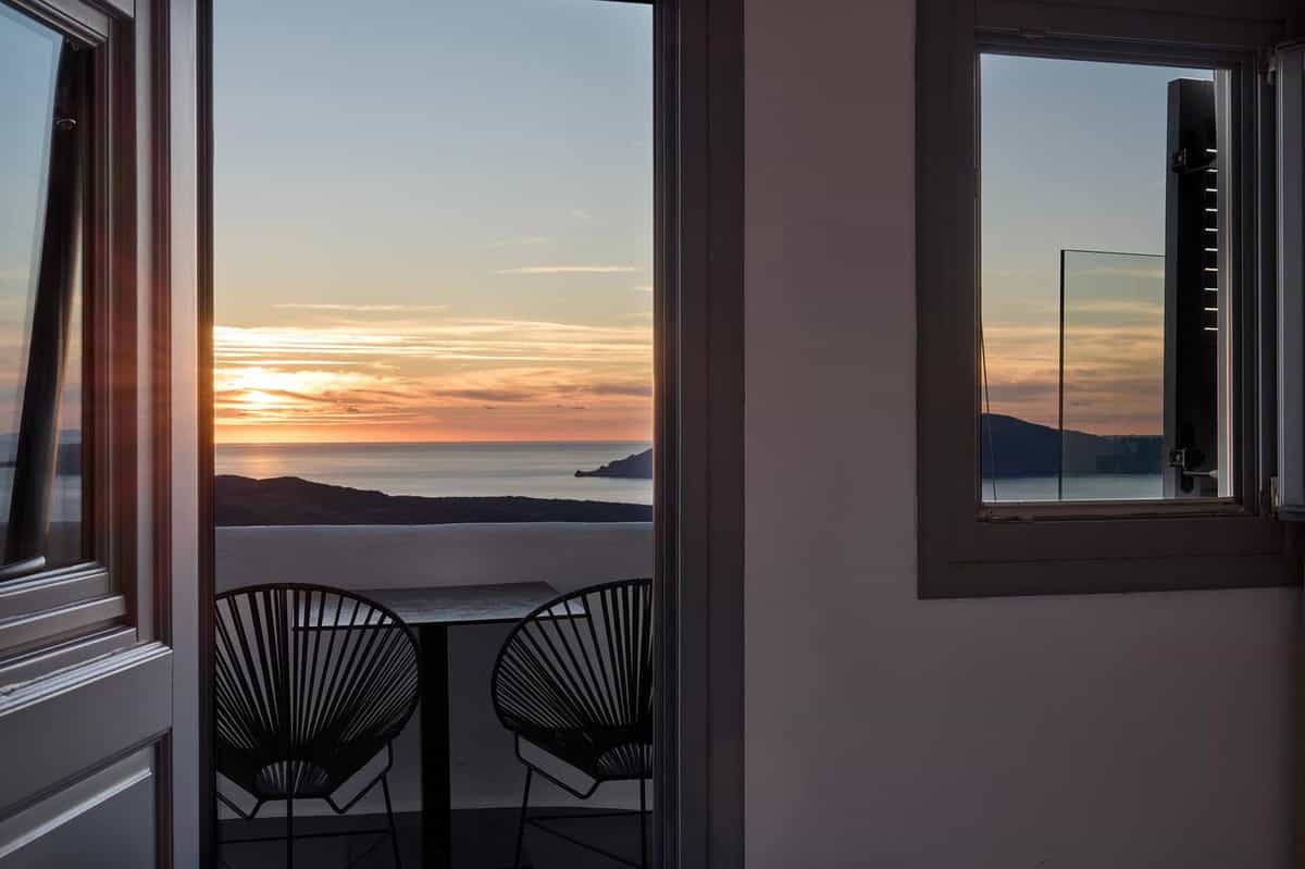 Sunset view from inside room through open door to balcony