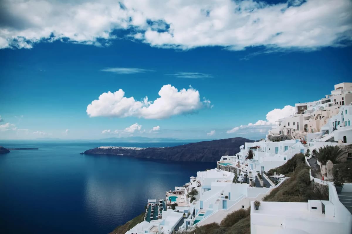 Panoramic view of the Santorini caldera with whitewashed buildings and blue Aegean Sea