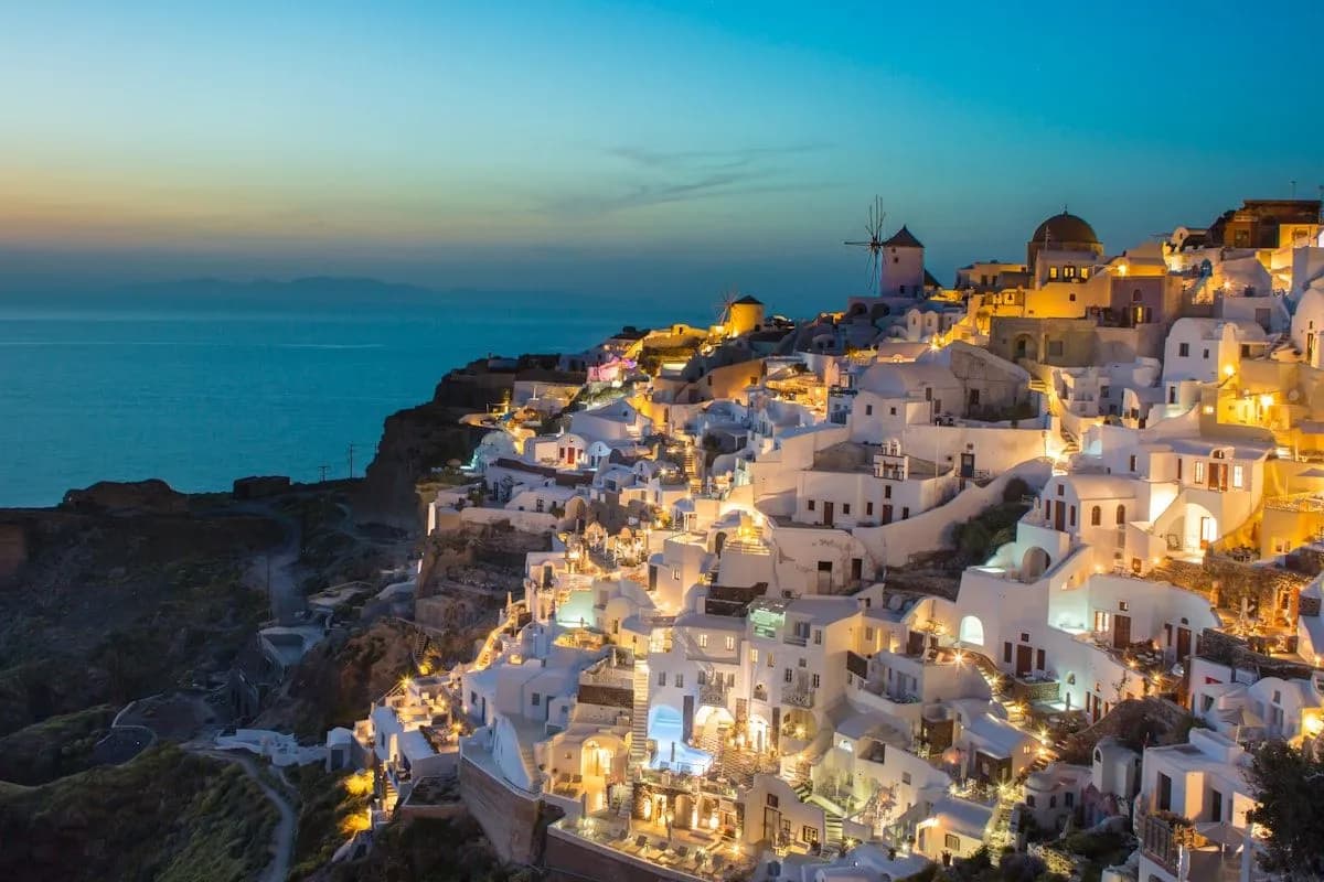 Walking path along the Santorini caldera rim with whitewashed buildings and sea views