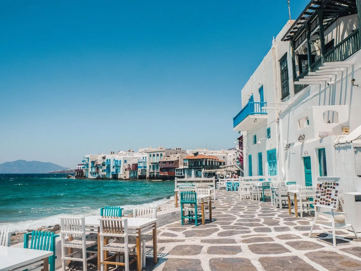 Little Venice waterfront in Mykonos, white houses with painted balconies over the sea