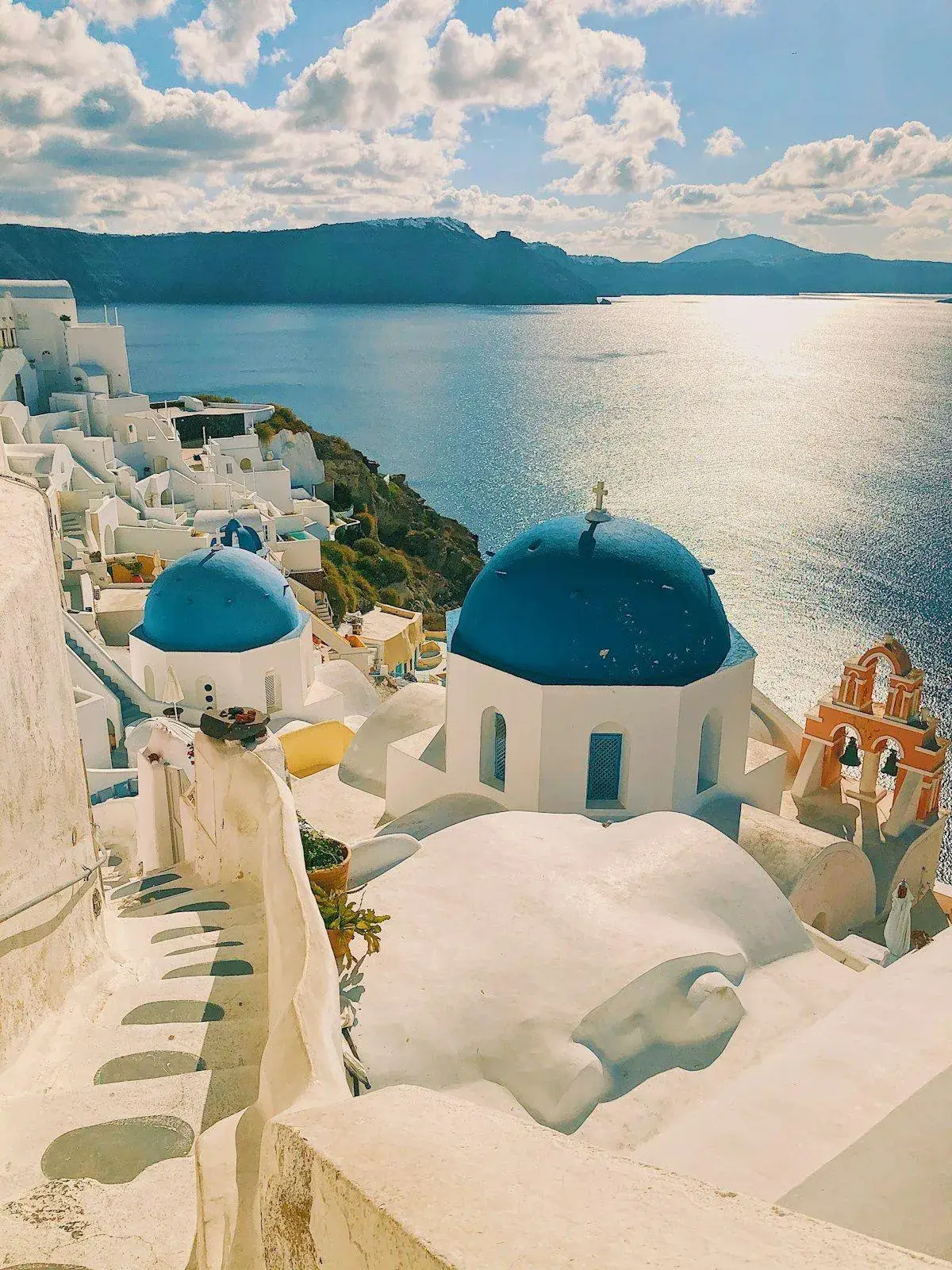 Blue-domed churches in Oia with the Aegean Sea stretching to the horizon
