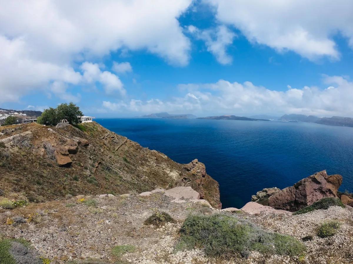 Rocky cliff overlooking the Santorini caldera with deep blue Aegean Sea below
